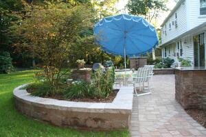 Paver Patio with Outdoor Kitchen and Fireplace and Raised Landscape Beds