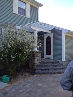 Pergola off house with Column and Paver Steps