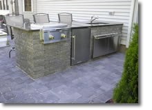 Outdoor Kitchen with Stainless Steel Grill on Paver Patio by Bahler Brother in CT, Western MA