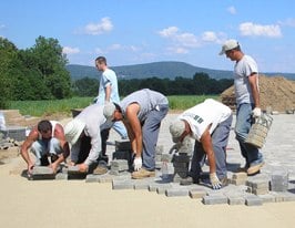 paver crew installing a paver driveway