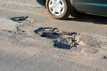pothole in asphalt driveway