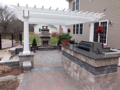 Paver Patio with Retaining Walls and Outdoor Fireplace and Outdoor Kitchen with Pergola