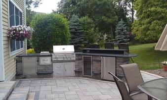Outdoor Kitchen with bar and Built-in Grill by Bahler Brothers in CT