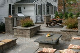 Multi-level paver patio with Walls, Outdoor Kitchen, Raised Planting Beds and Built-in Seating