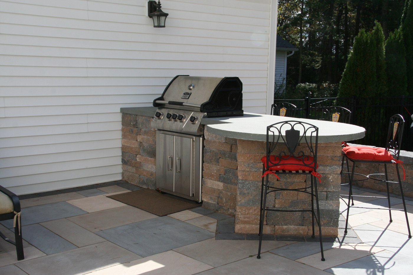 Outdoor Kitchen with Built-in Grill and Bar by Bahler Brothers in CT