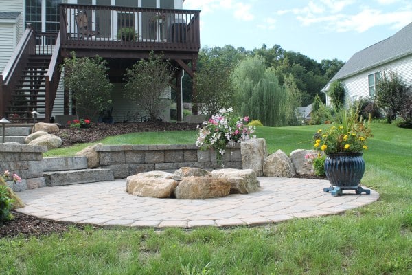 Paver Patio with Fire Pit and Retaining Walls Leading to Deck