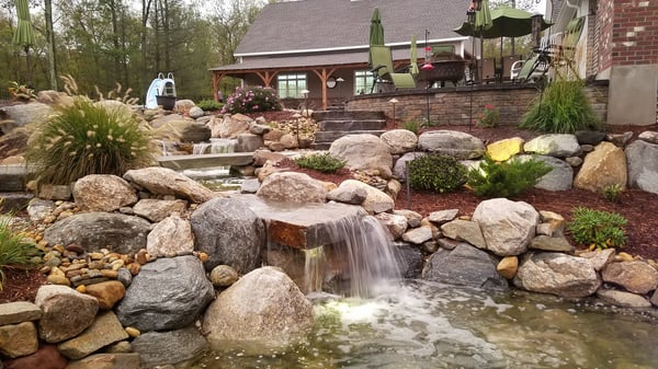 large water fall and pond with bridge and wading pool
