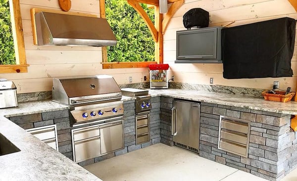 Outdoor living space with a grill and cabinetry