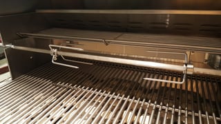 The rotisserie rack and burner of a Summerset grill.