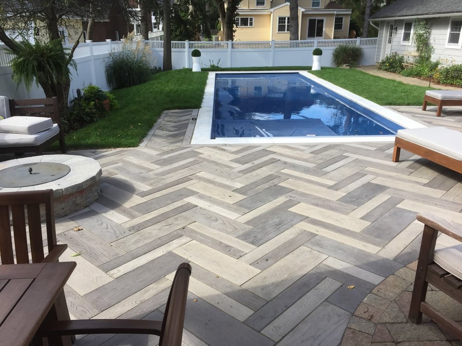 Custom backyard paver patio with pool and fire-pit 